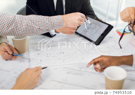 Close up of people hands drawing project of new building 74953510