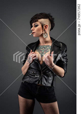 Young woman wearing a jacket with nothing underneath she also has a  tattooed chest Stock Photo - Alamy