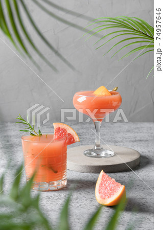 Two rosemary grapefruit sodas on grey. 74957646