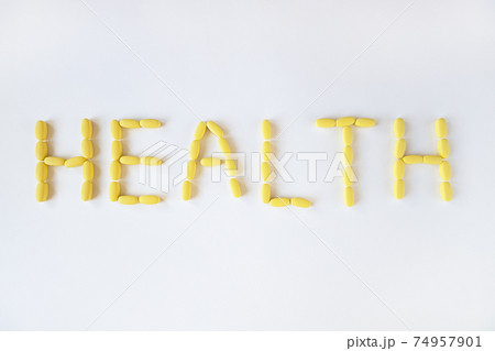 Inscription HEALTH from yellow long pills on white background, macro, close-up, copy space. Nutritional supplements concept, health, vitamins, trendy color of 2021, Illuminating. Horizontal Inscription HEALTH from yellow long pills on white background, macro, close-up, copy space. Nutritional supplements concept, health, vitamins, trendy color of 2021, Illuminating. Horizontal 74957901