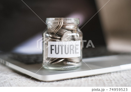 The concept of saving money for the future - a glass jar with coins. 74959523