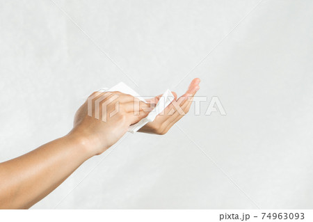 Woman cleaning her hands with white soft tissue paper. isolated on a white backgrounds Woman cleaning her hands with white soft tissue paper. isolated on a white backgrounds 74963093