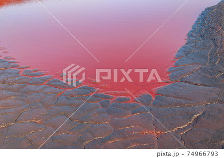 Close-up of red water polluted with iron ore waste Close-up of red water polluted with iron ore waste 74966793