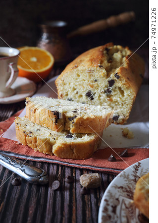 Orange cake with chocolate, powdered sugar dressing for coffee break Orange cake with chocolate, powdered sugar dressing for coffee break 74971226