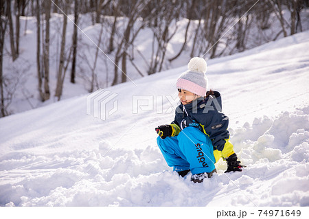 スキー場のゲレンデの上にスキーウェアーを着た女の子が立っている winter スキー場のゲレンデの上にスキーウェアーを着た女の子が立っている winter 74971649