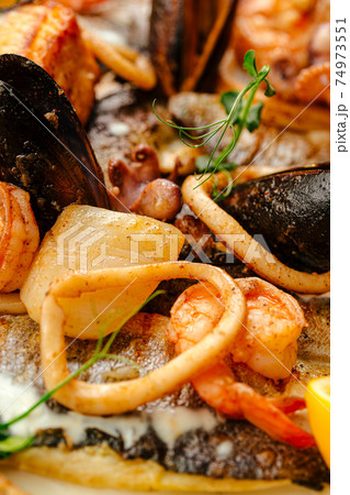 Closeup on seafood saute mix with cream sauce 74973551