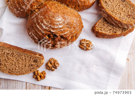 Top view on rye walnut bread on the wooden table 74973903