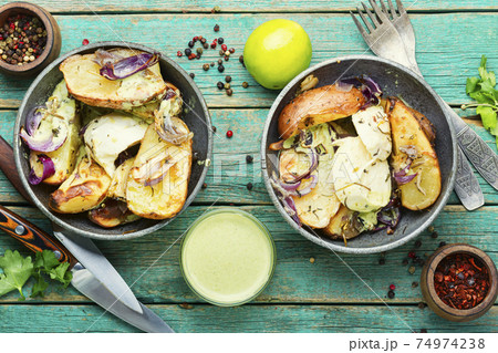 Appetizing baked potatoes Appetizing baked potatoes 74974238