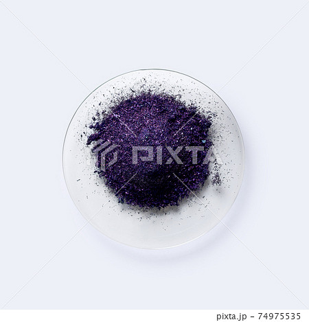 Potassium permanganate on chemical watch glass. KMnO4, a common chemical compound that combines manganese oxide ore with potassium hydroxide. Potassium permanganate on chemical watch glass. KMnO4, a common chemical compound that combines manganese oxide ore with potassium hydroxide. 74975535
