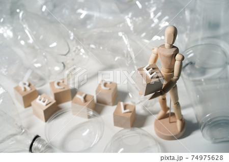 Wooden man and wooden cubes with the text RECYCLE 74975628