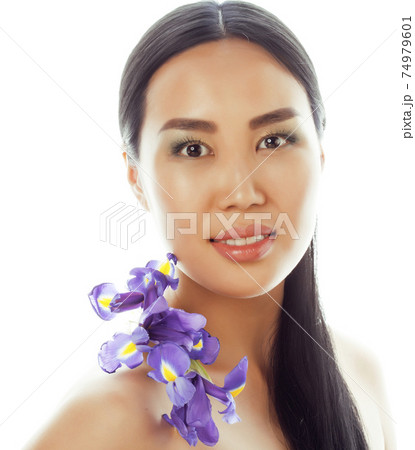 young pretty real asian woman with flower purple orchid isolated on white background spa, healthcare concept 74979601
