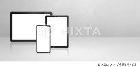 Mobile phone and digital tablet pc on white concrete office desk. Background banner 74984733