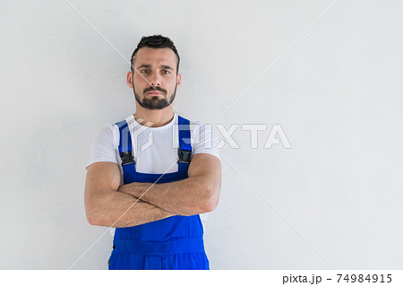 Bearded worker in overalls looking at the camera 74984915