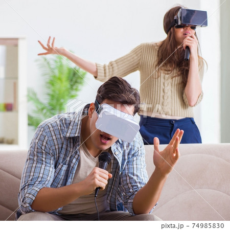 Pair singing karaoke with virtual reality glasses Pair singing karaoke with virtual reality glasses 74985830