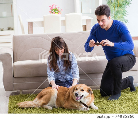 Happy family with golden retriever dog 74985860
