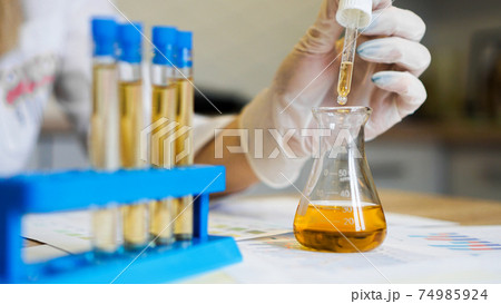 Woman making urine test with ph material in laboratory Woman making urine test with ph material in laboratory 74985924
