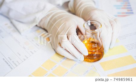 Woman making urine test with ph material in laboratory Woman making urine test with ph material in laboratory 74985961