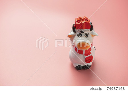 bull figurine on a pink background. symbol of 2021 74987168