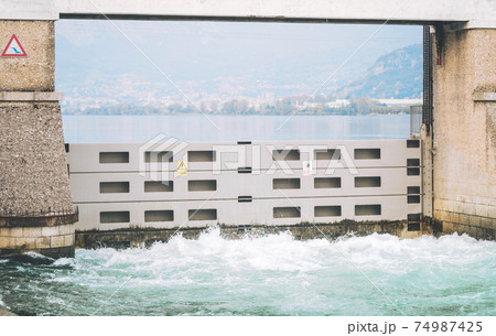 Italian dam - Diga di Olginate - divides the lakes Garlate and Olginate, regulates the Lake Como level and distribute outflows between the irrigation and hydroelectric utilities 74987425
