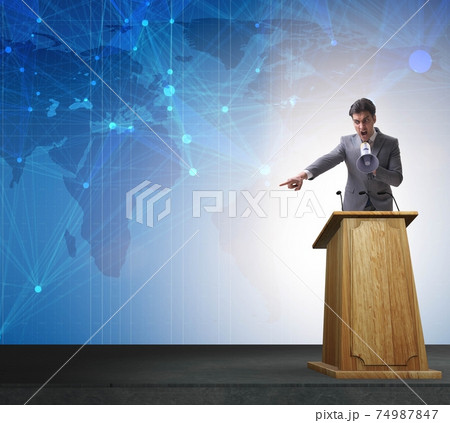 Man businessman making speech at rostrum in business concept 74987847