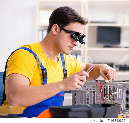 Computer repair technician repairing hardware Computer repair technician repairing hardware 74988095