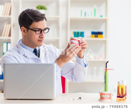 Young dentist working in the dentistry hospital 74988376