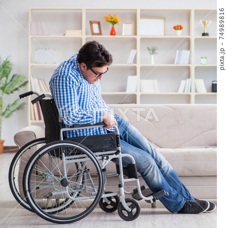 Young student on wheelchair in disability concept Young student on wheelchair in disability concept 74989816