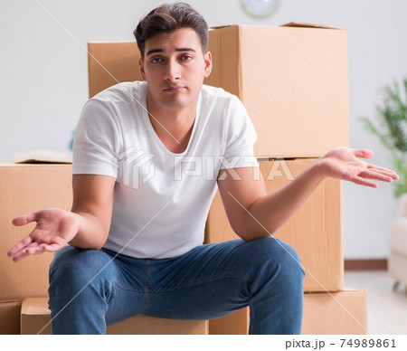 Man caryying boxes at home 74989861