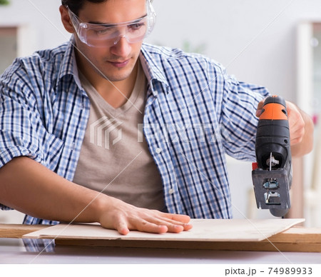 Young man in woodworking hobby concept Young man in woodworking hobby concept 74989933