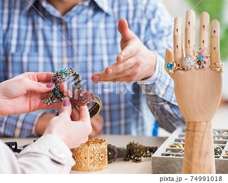 Woman visiting jeweler for jewelery evaluation Woman visiting jeweler for jewelery evaluation 74991018