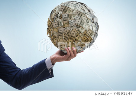 Businessman with heavy dollar ball 74991247