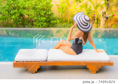Portrait beautiful young asian woman enjoy relax around swimming pool 74991824