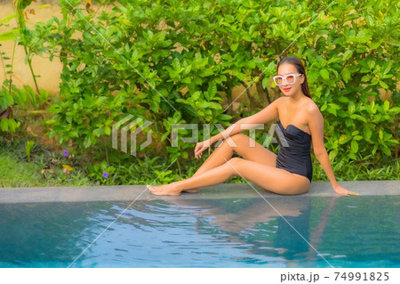 Portrait beautiful young asian woman enjoy relax around swimming pool Portrait beautiful young asian woman enjoy relax around swimming pool 74991825