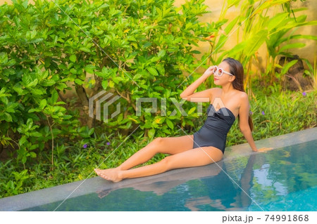 Portrait beautiful young asian woman enjoy relax around swimming pool 74991868