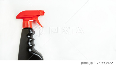Concept of cleaning company or household cleaning. Black bottle of household spray on a bulom background with room for text Concept of cleaning company or household cleaning. Black bottle of household spray on a bulom background with room for text 74993472