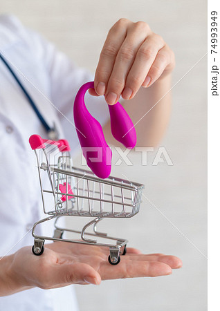 The faceless gynecologist recommends buying a clitoral vaginal vibrator to maintain women's health. The doctor holds a mini trolley and a masturbator for vivid orgasms. The faceless gynecologist recommends buying a clitoral vaginal vibrator to maintain women's health. The doctor holds a mini trolley and a masturbator for vivid orgasms. 74993949