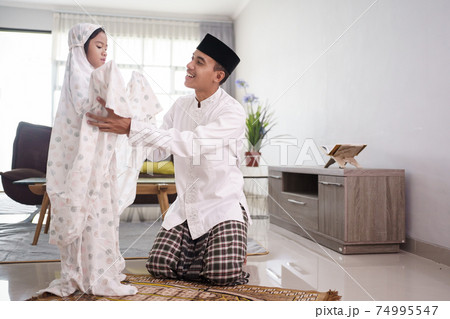 muslim father teaching her daughter how to pray at home muslim father teaching her daughter how to pray at home 74995547