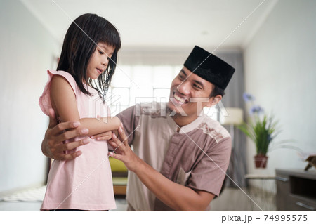 muslim father teaching her daughter how to pray at home muslim father teaching her daughter how to pray at home 74995575