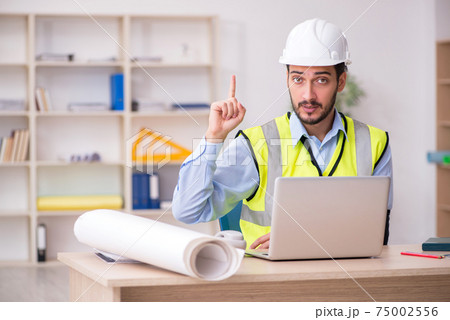 Young arm injured male architect working in the office Young arm injured male architect working in the office 75002556