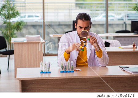 Young male chemist in drug synthesis concept Young male chemist in drug synthesis concept 75003171