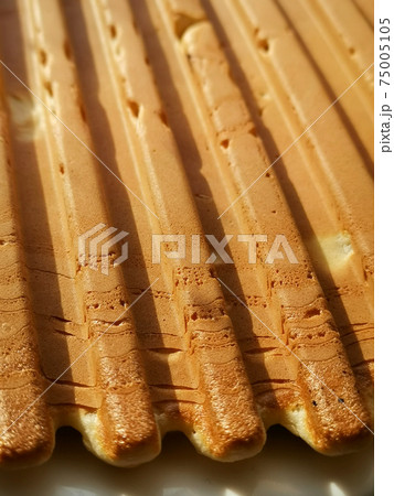 Vertical shot of appetizing homemade waffles Vertical shot of appetizing homemade waffles 75005105