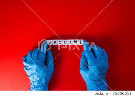 Medical covid-19 concept. Doctor hand with words 'vaccine'. Medical covid-19 concept. Doctor hand with words 'vaccine'. 75006013