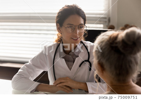 Close up smiling female doctor wearing glasses consulting mature patient Close up smiling female doctor wearing glasses consulting mature patient 75009751