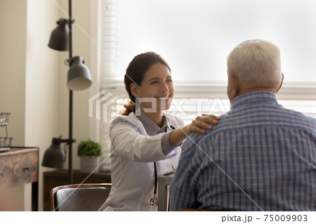 Rear view smiling female doctor comforting mature man, touching shoulder 75009903