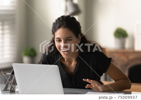 Close up surprised overjoyed woman looking at laptop screen Close up surprised overjoyed woman looking at laptop screen 75009937