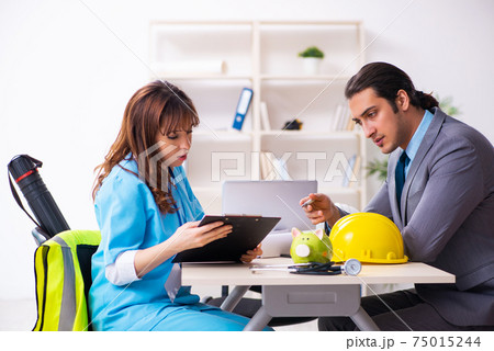 Young businessman and female doctor discussing construction proj 75015244