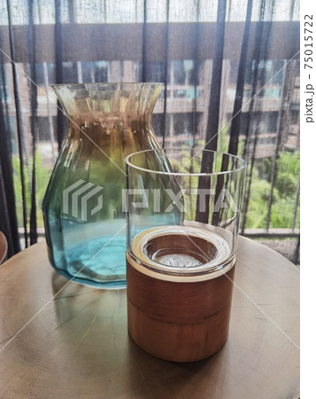 Candlestick and vase on a wooden table 75015722