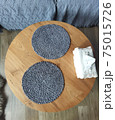 Grey round napkins on a wooden table 75015726