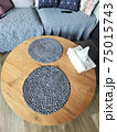 Grey round napkins on a wooden table 75015743