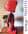 Red lamp robot side on the wooden desk 75015774